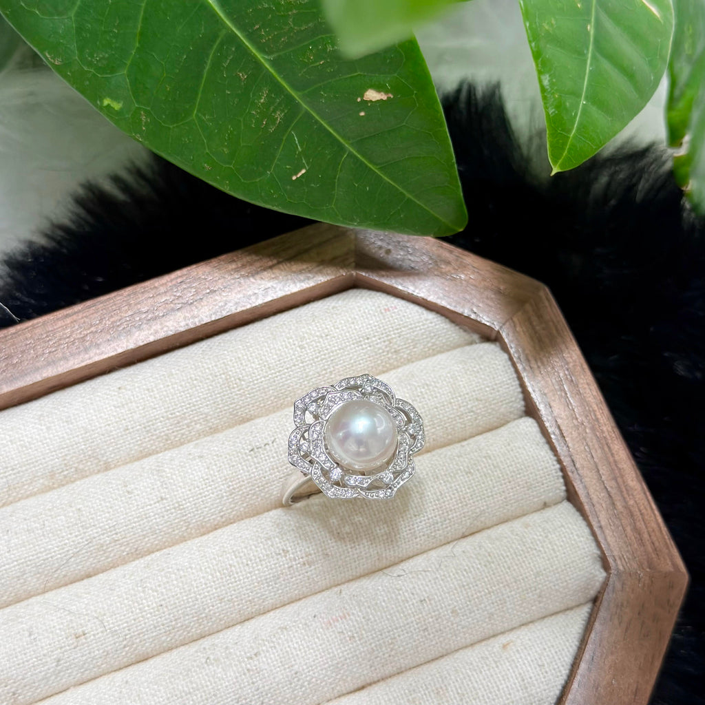 Soft pink halo freshwater pearl set in a sparkling camellia flower ring.