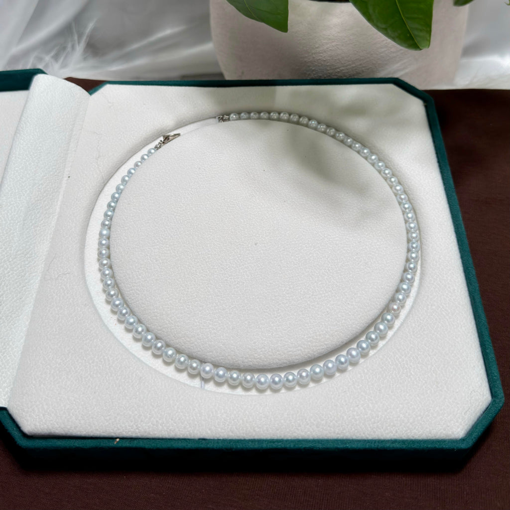 Mirror-lustre freshwater pearls showing luminous blue reflections.
