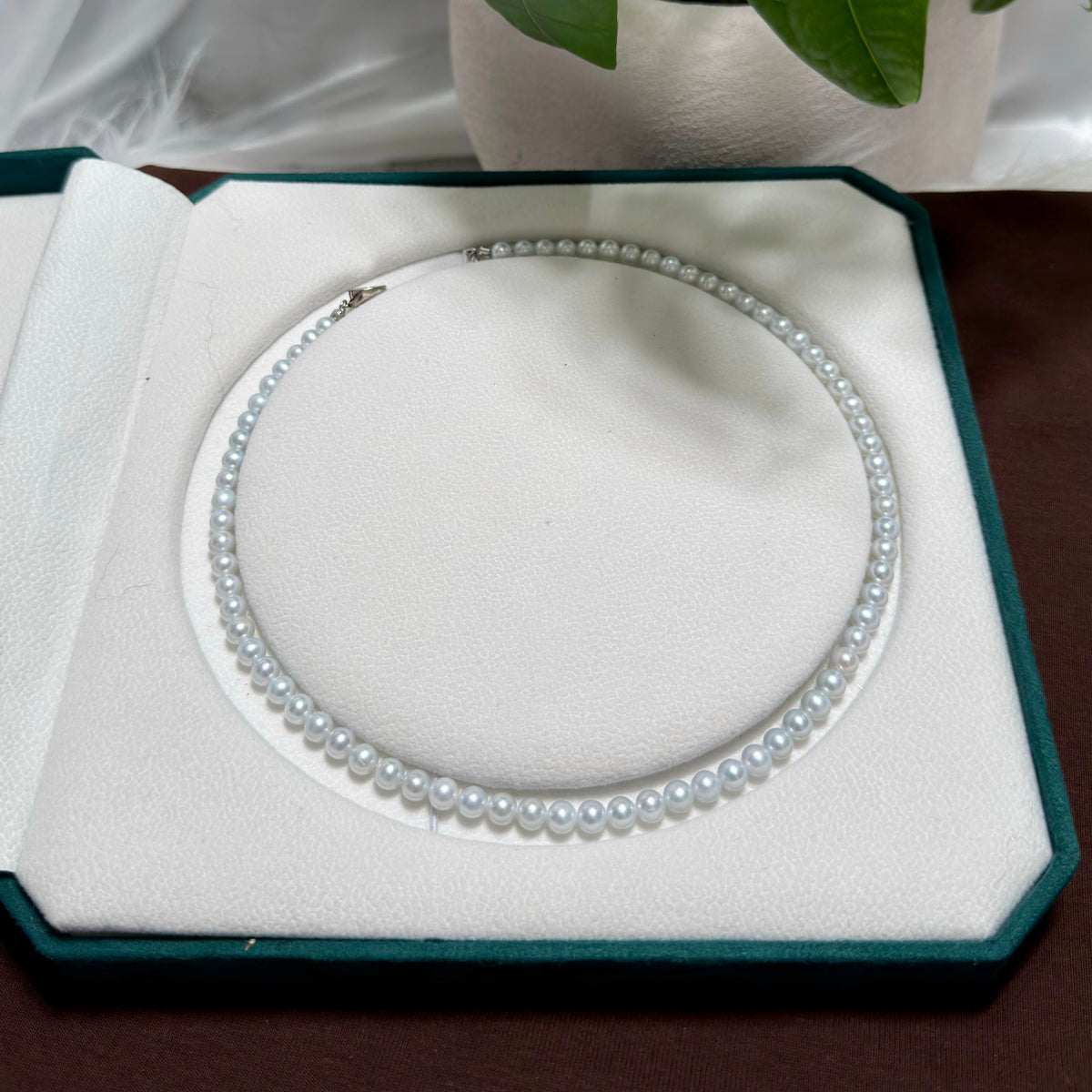 Mirror-lustre freshwater pearls showing luminous blue reflections.
