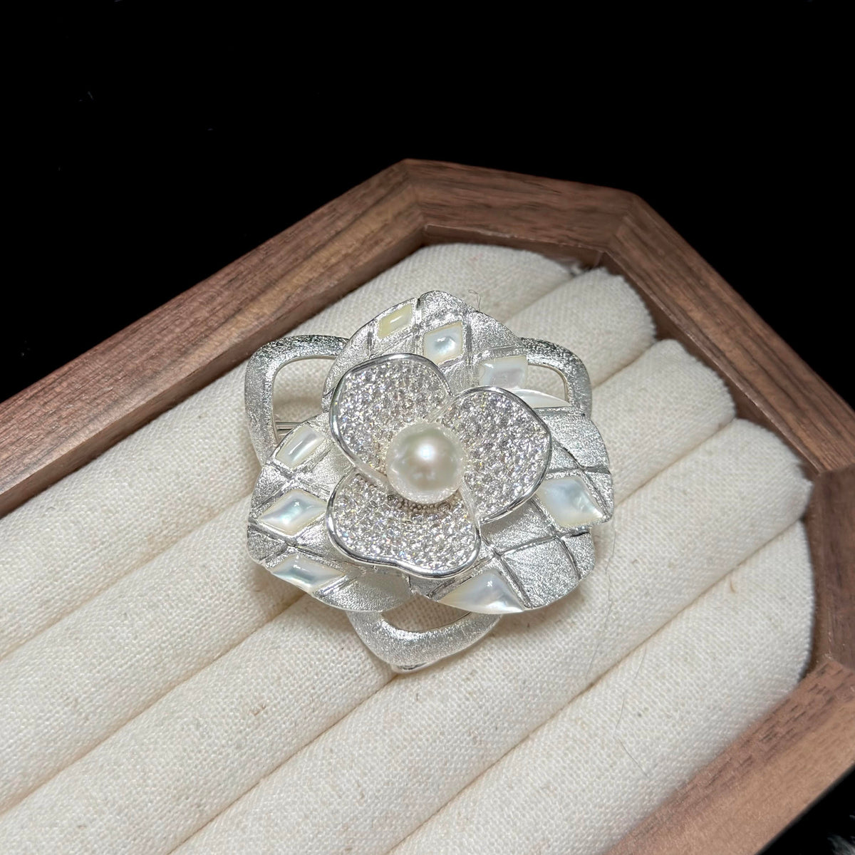 18K white gold plated camellia brooch featuring a 9 mm freshwater pearl.
