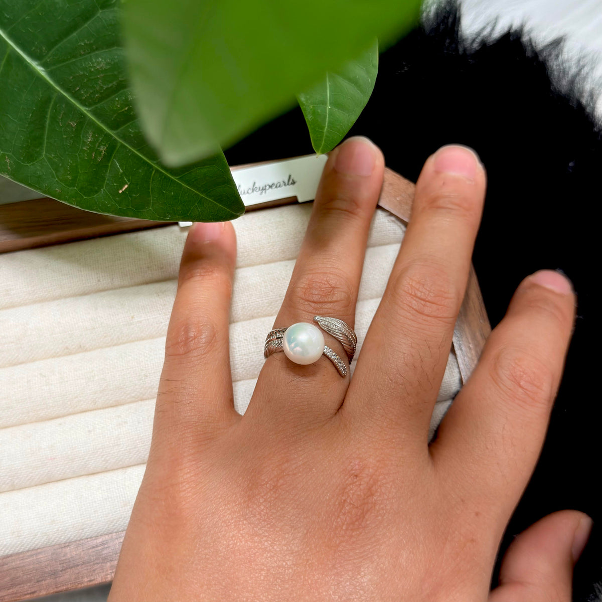 White freshwater pearl ring with an open adjustable band.