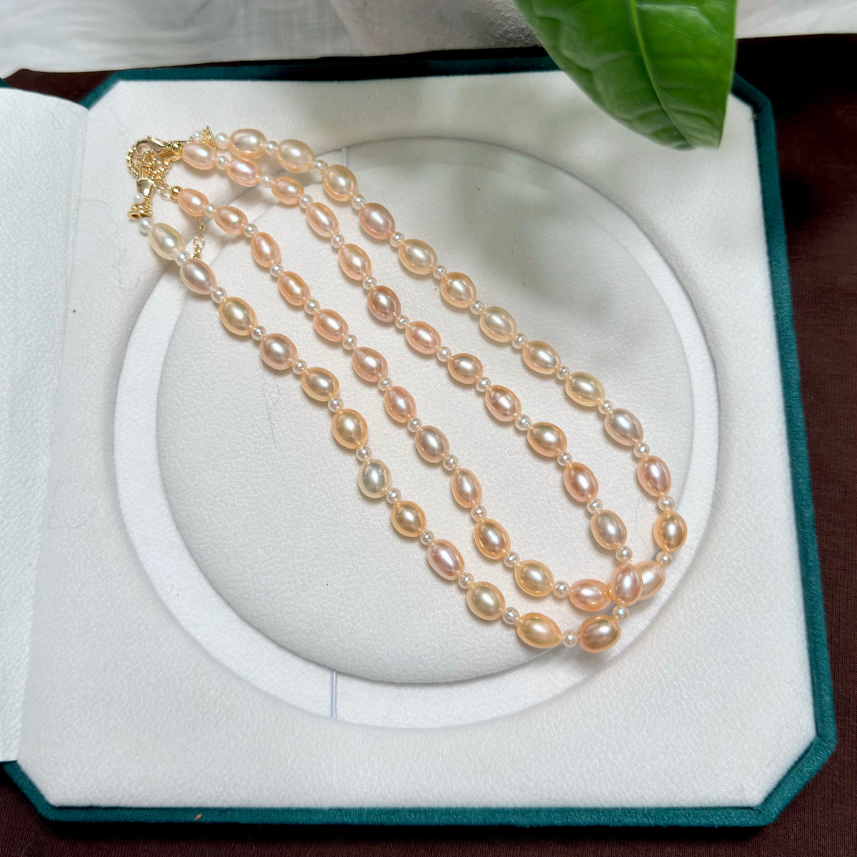 Warm-toned freshwater pearl necklace with elegant golden-orange colour.