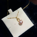 Golden-pink 10.3 mm freshwater pearl pendant with an openable bail.