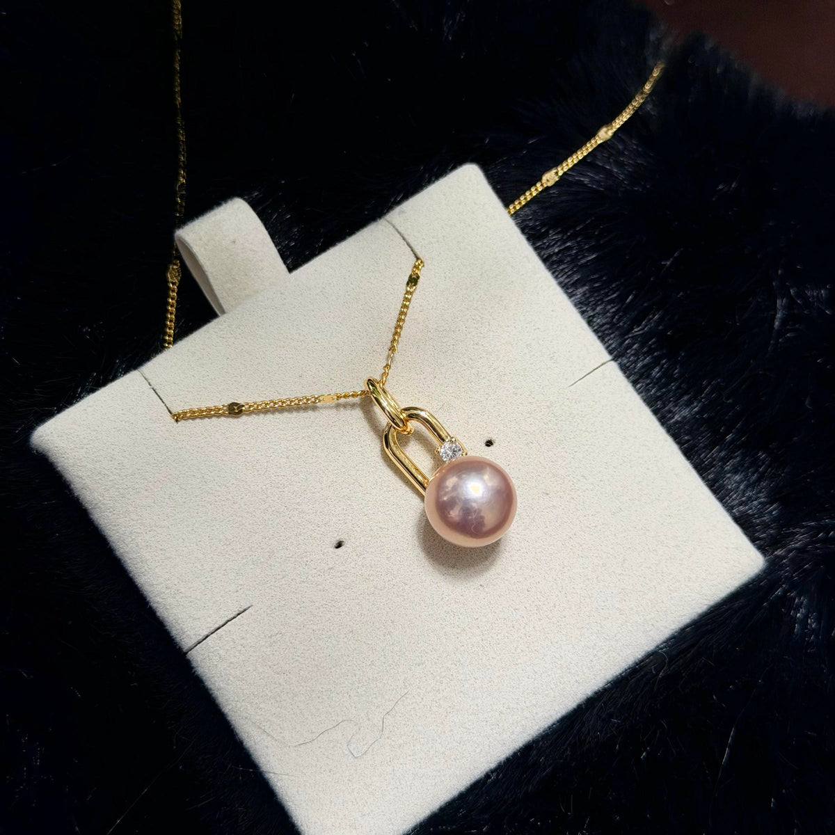 Golden-pink 10.3 mm freshwater pearl pendant with an openable bail.