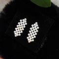 Woven check earrings featuring luminous 4.5 mm white freshwater pearls.