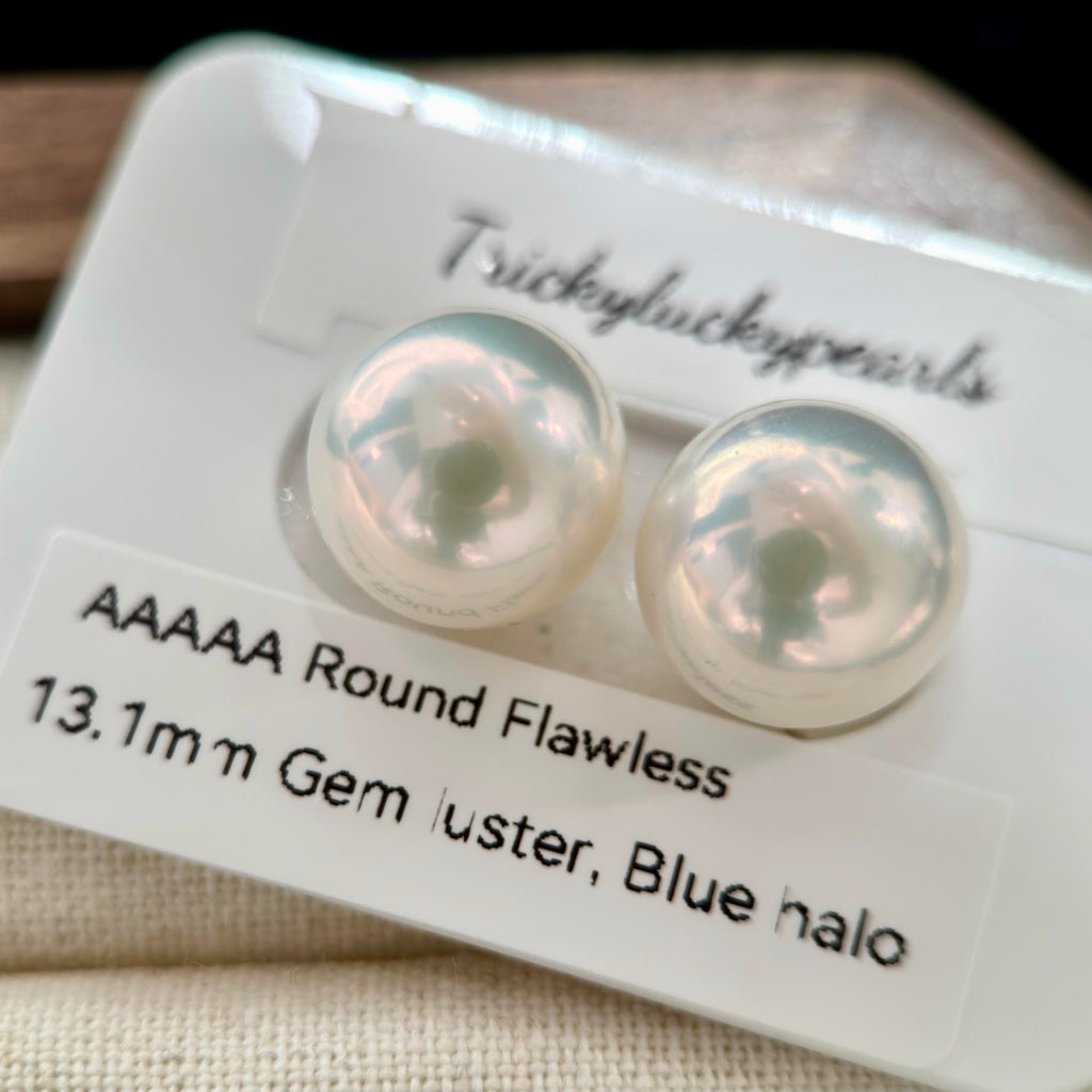 Natural 13.1 mm freshwater pearl earrings with near-round shape.