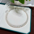 Cool white with silver-blue halo freshwater pearl strand with 10 mm pearls.