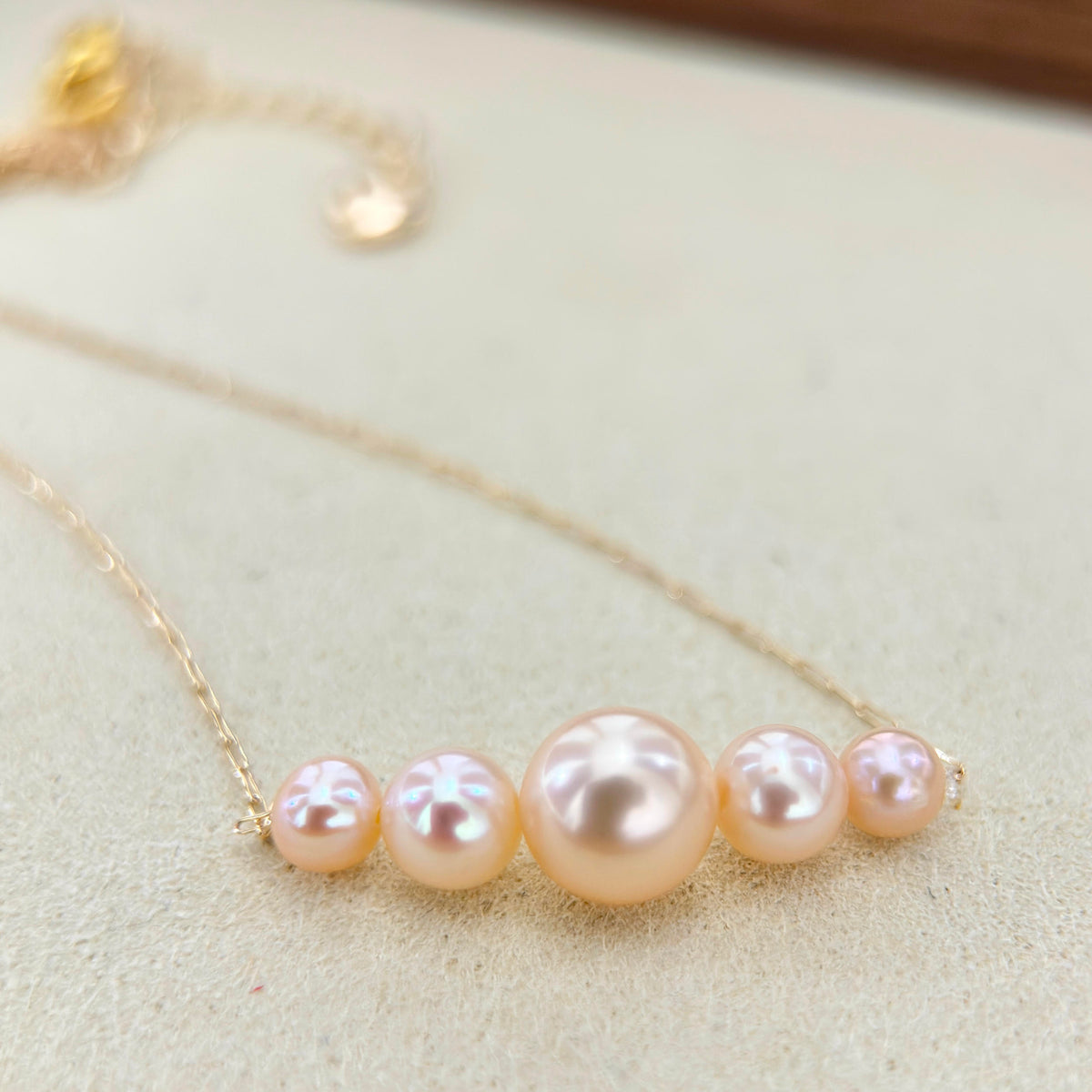 Natural freshwater pearl necklace with warm golden and orange tones.
