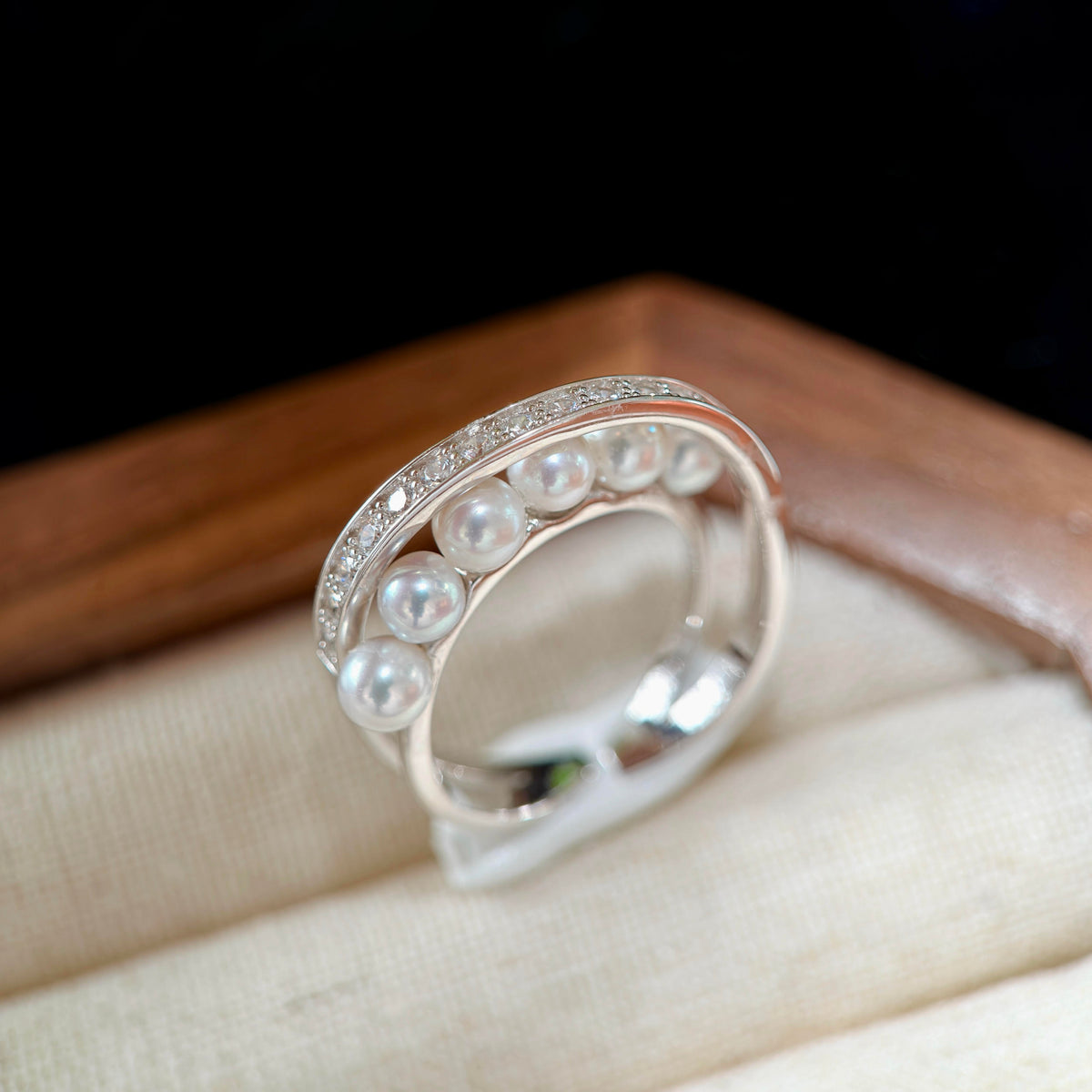Silver star-trail inspired pearl ring with luminous white freshwater pearls.
