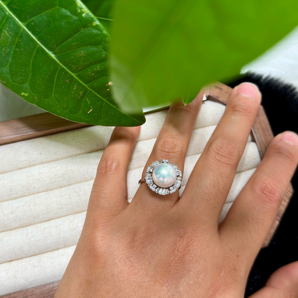 Natural white freshwater pearl ring with sparkling surround.