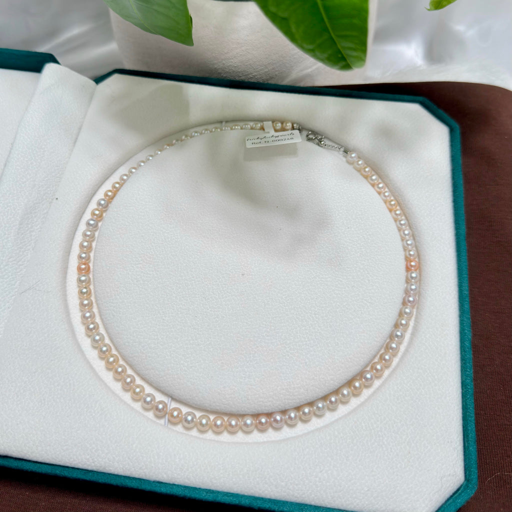 Mixed white and soft golden tones freshwater pearl strand with 5–6 mm pearls.