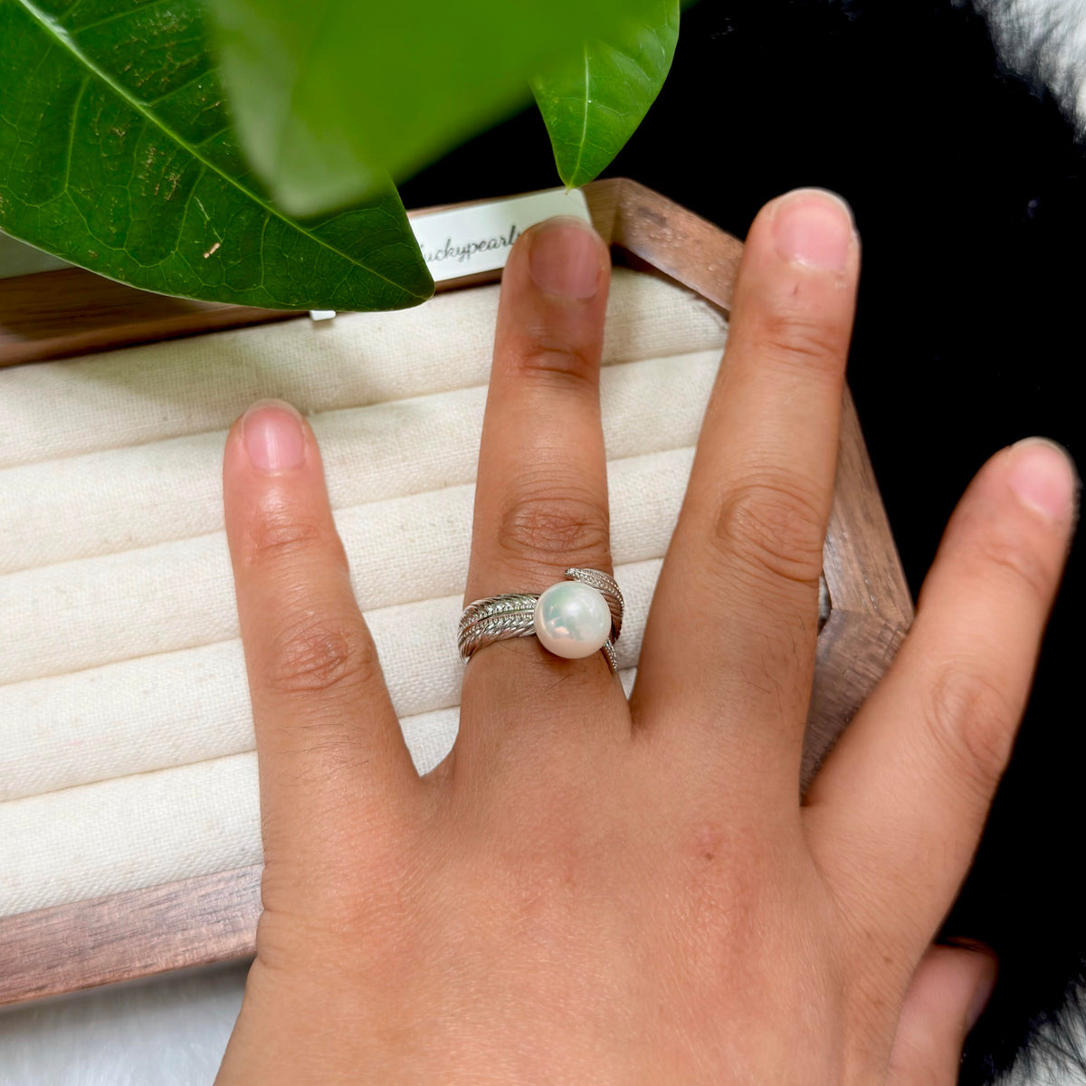 Adjustable sterling silver feather ring with natural white pearl.