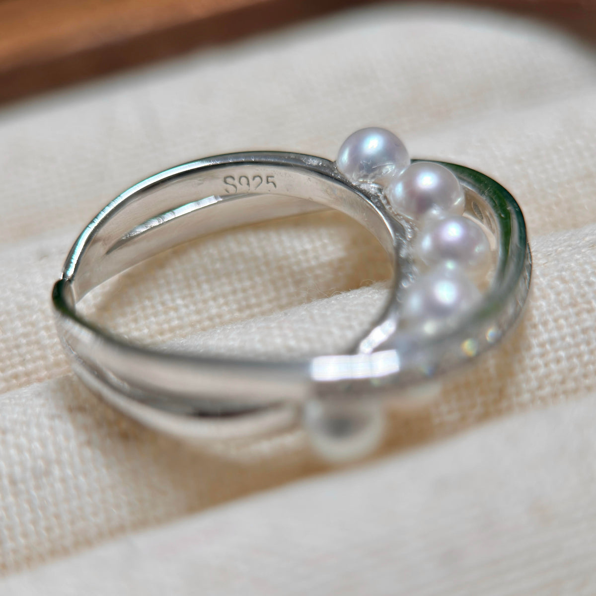 Adjustable silver open ring with bright white freshwater pearls.