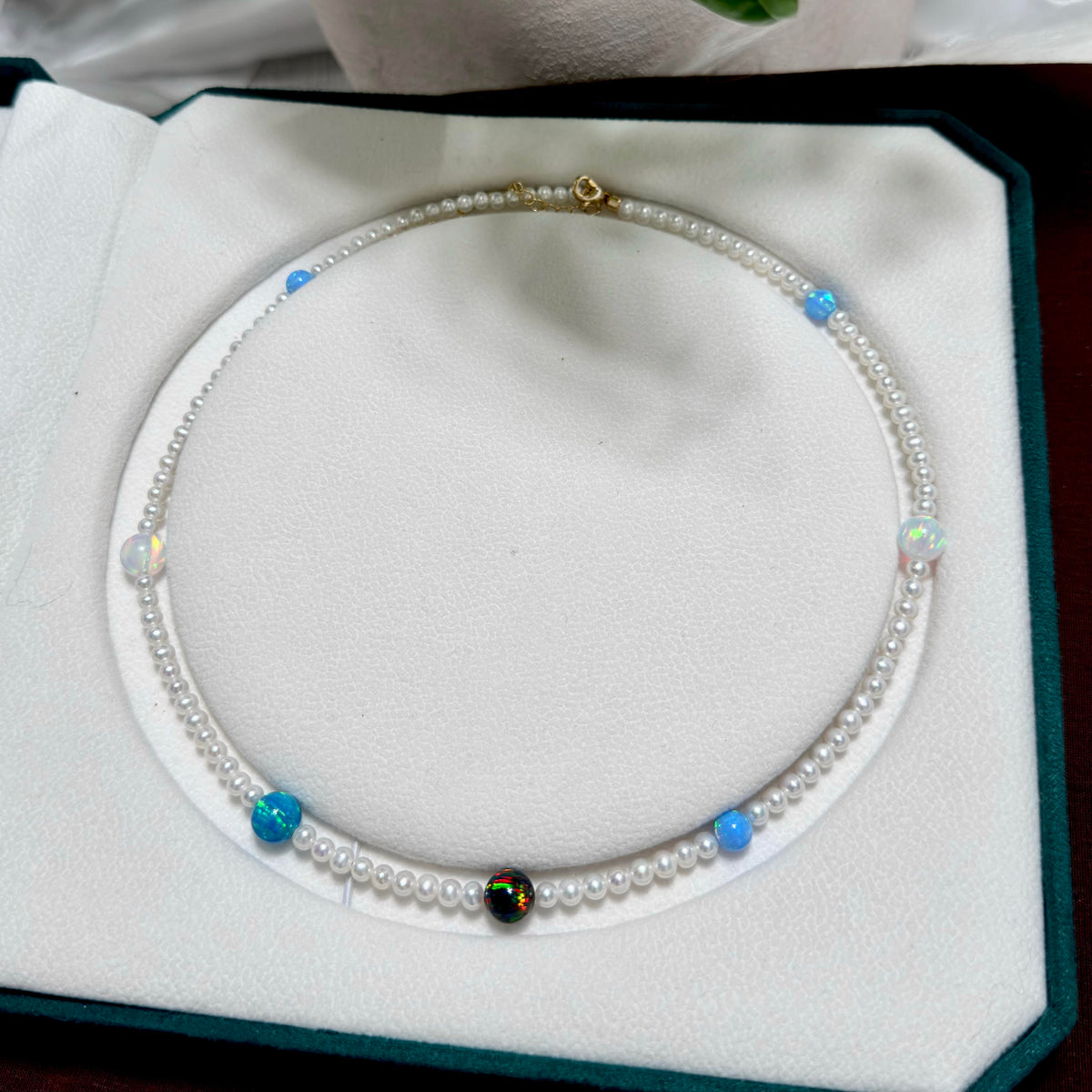 4.5 mm luminous white freshwater pearls paired with colourful opals.
