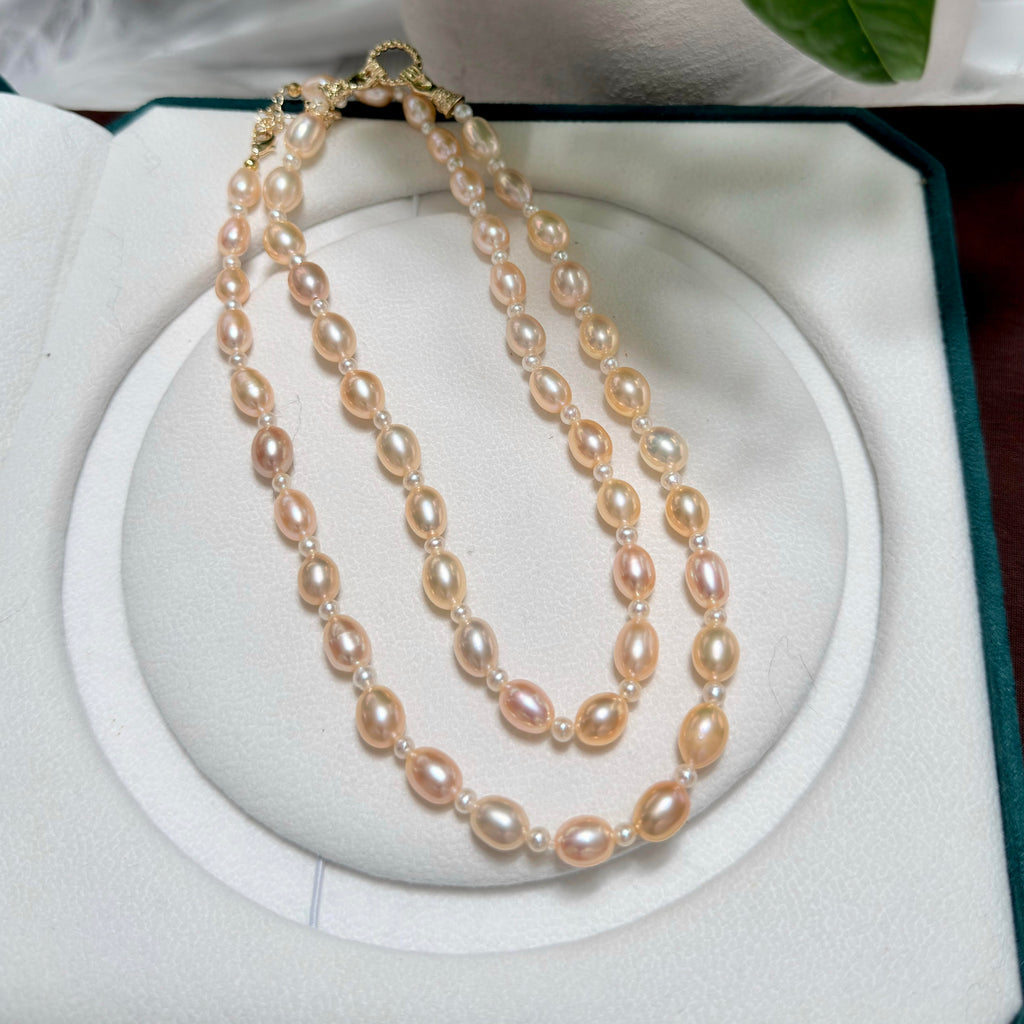 Natural freshwater pearl necklace featuring luminous golden-orange oval pearls.