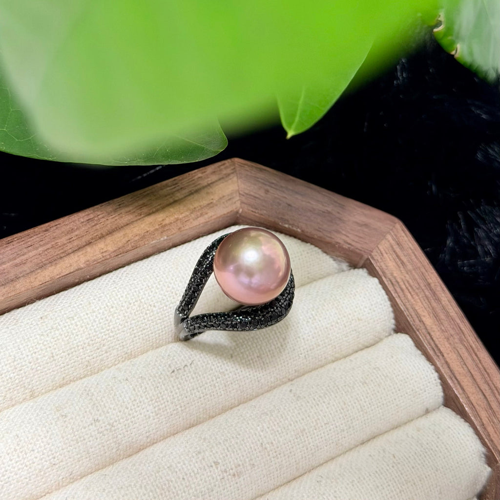 Dramatic pearl ring surrounded by black zircon stones.
