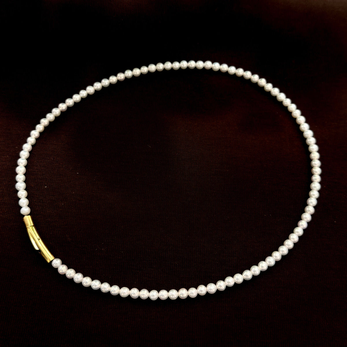 Close-up of petite 3.5 mm bright white freshwater pearls.