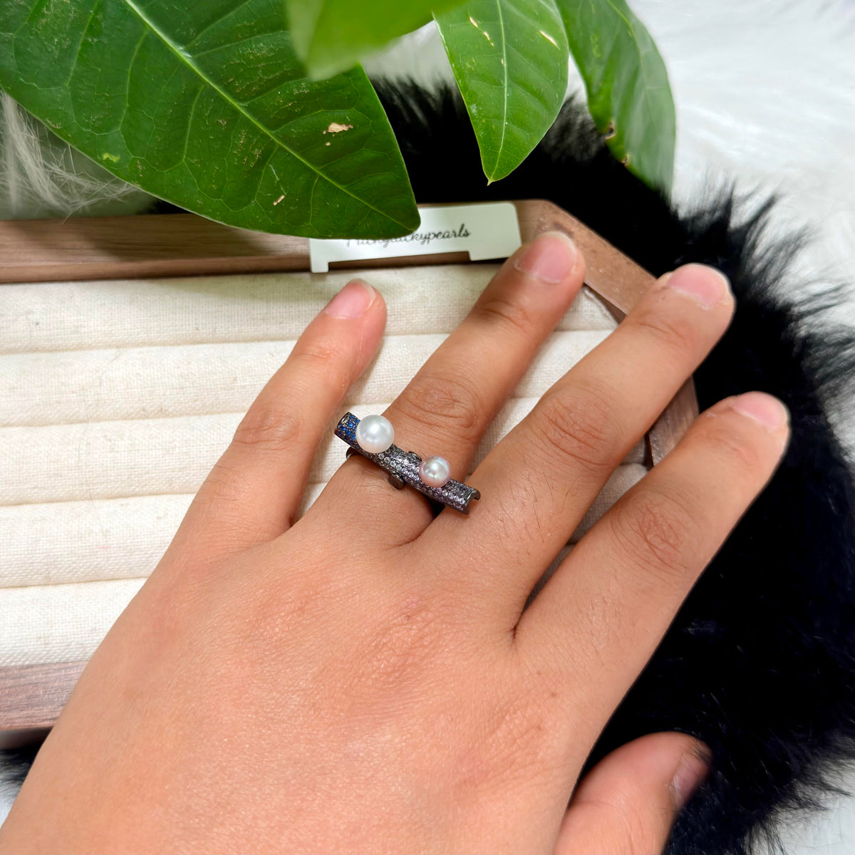 Two-pearl kinetic statement ring with movable centre detail.
