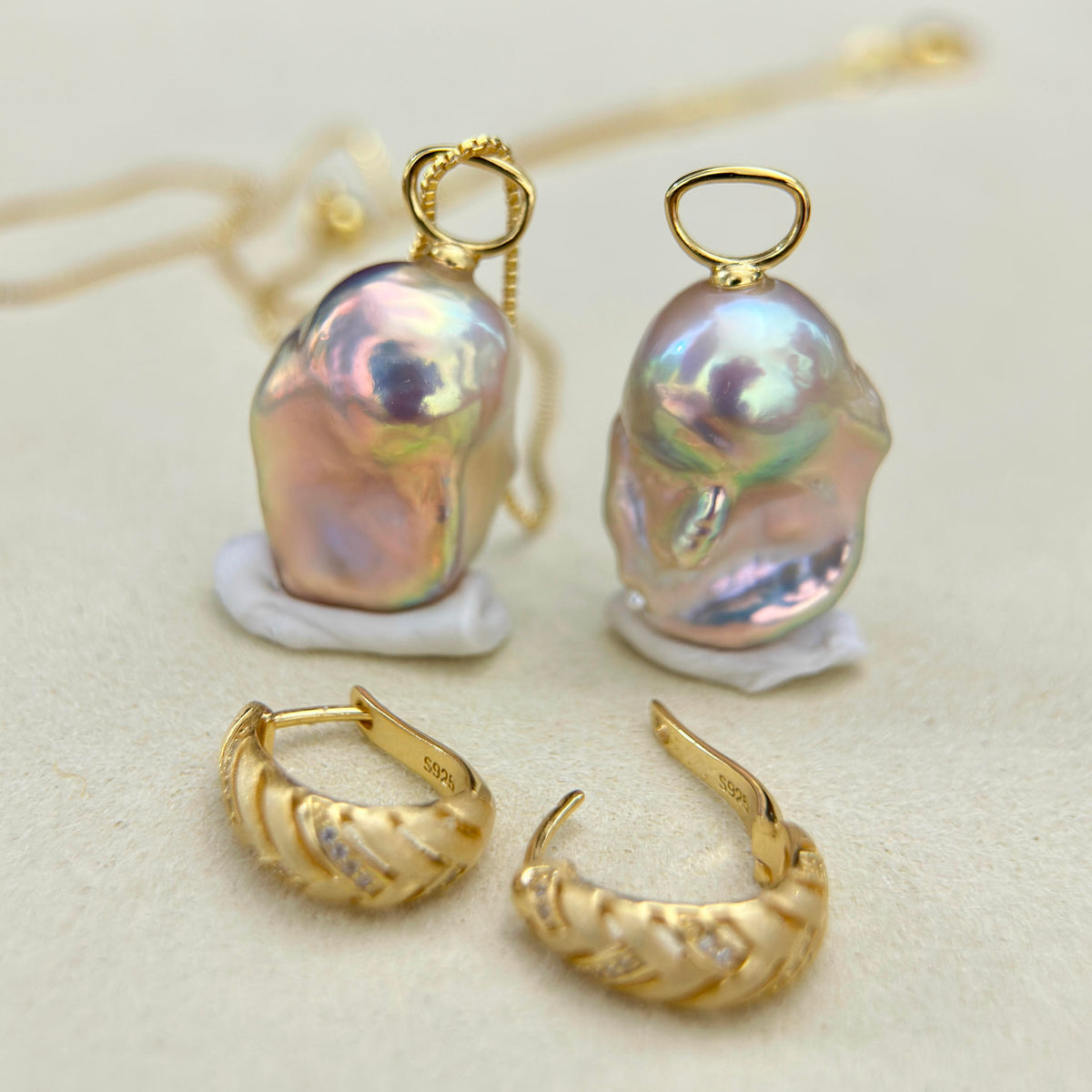 Convertible pearl earrings with a frosted matte gold finish.