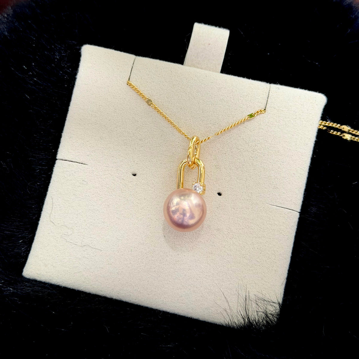 Close-up of a golden-pink pearl displaying vivid Aurora lustre.