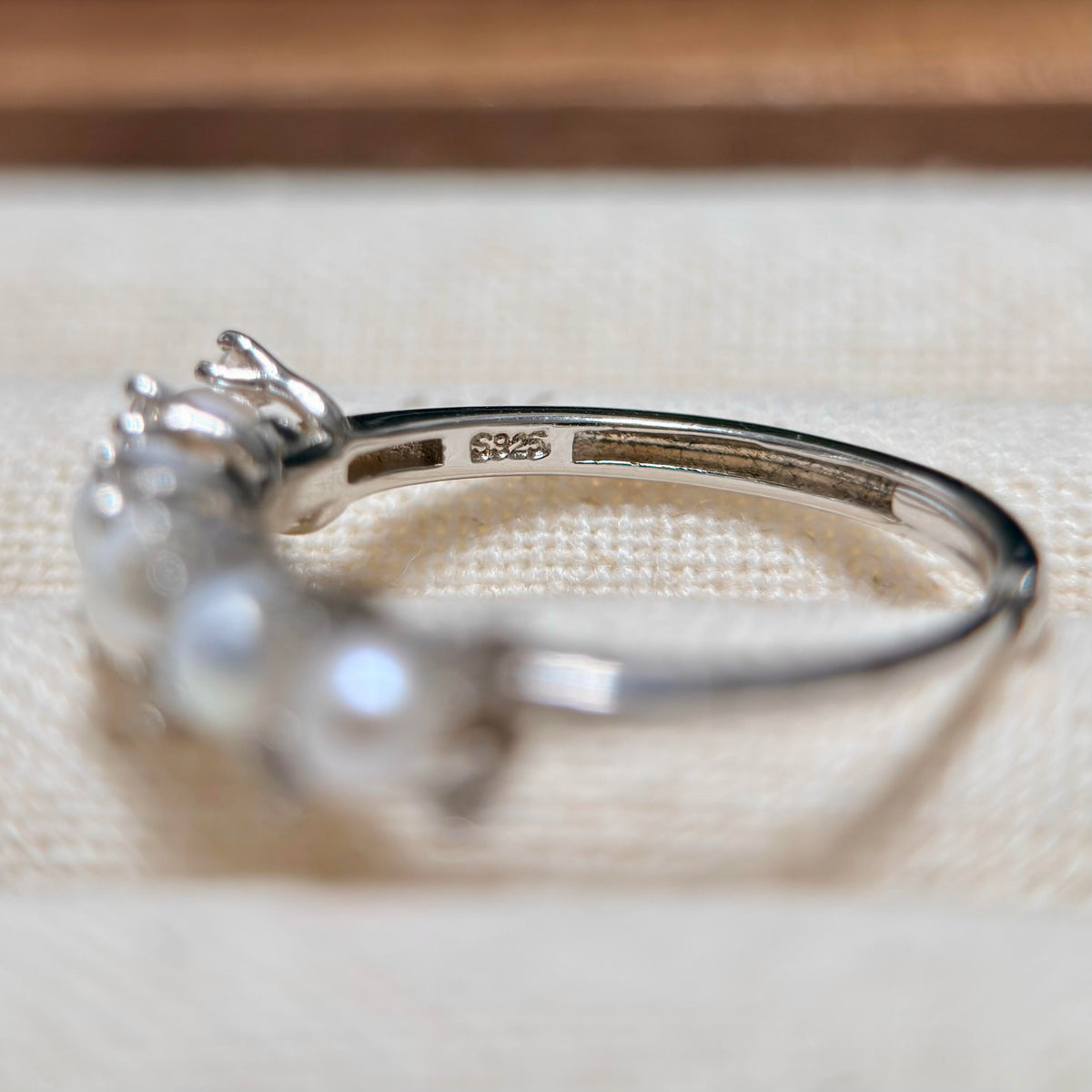 Adjustable pearl cluster ring with sparkling cubic zirconia.