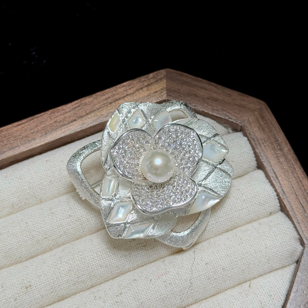 Classic floral brooch featuring a luminous white freshwater pearl centerpiece.