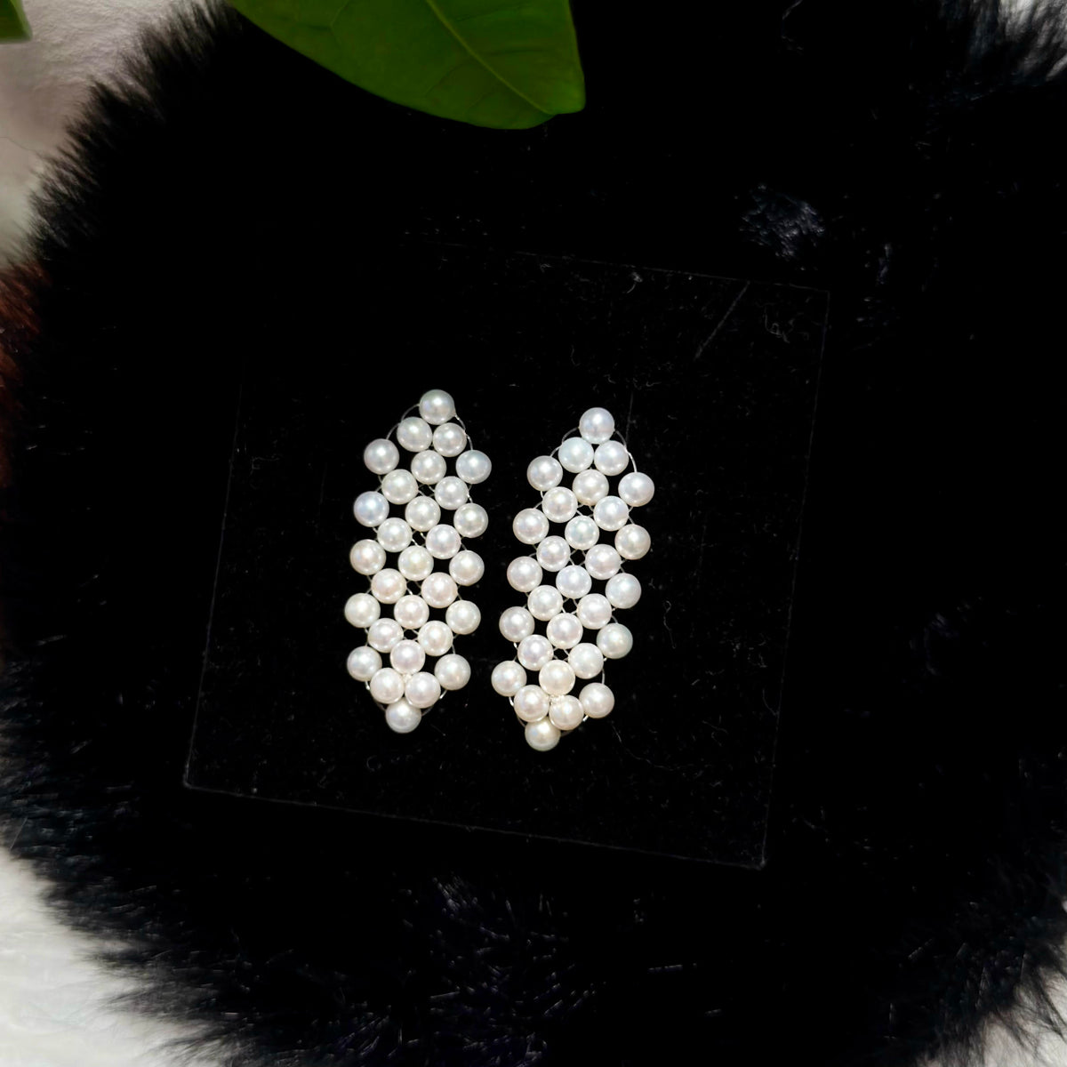 Elegant pearl drop earrings with sterling silver settings.