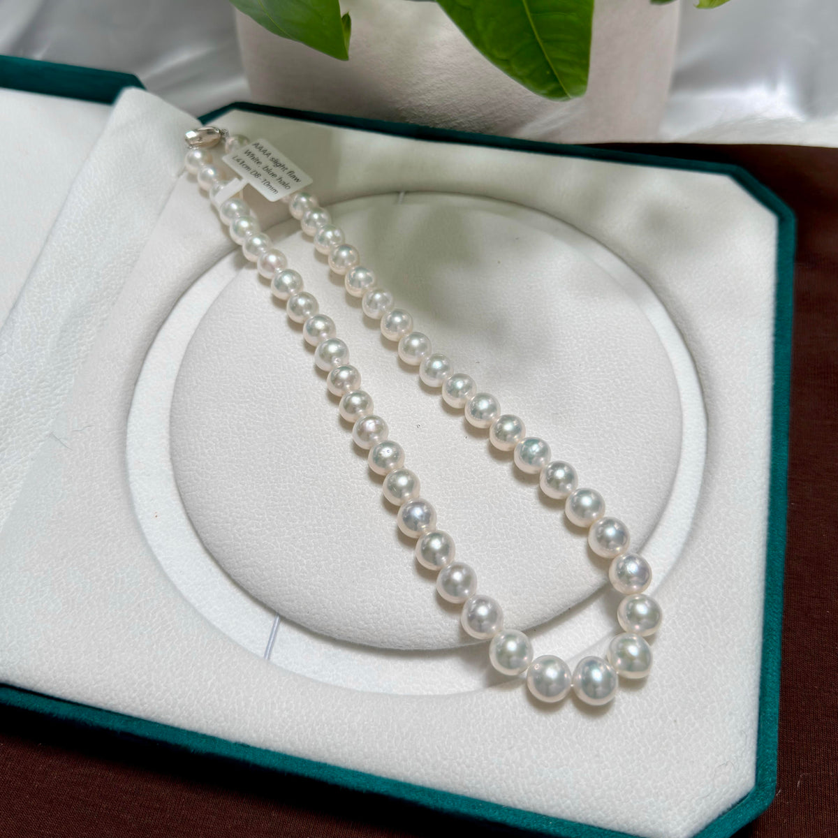 Full strand view of 10 mm cool white with silver-blue halo freshwater pearl necklace, 42 cm long.