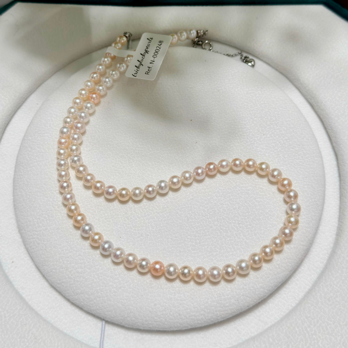 Classic single-strand freshwater pearl necklace in mixed white and soft golden tones.