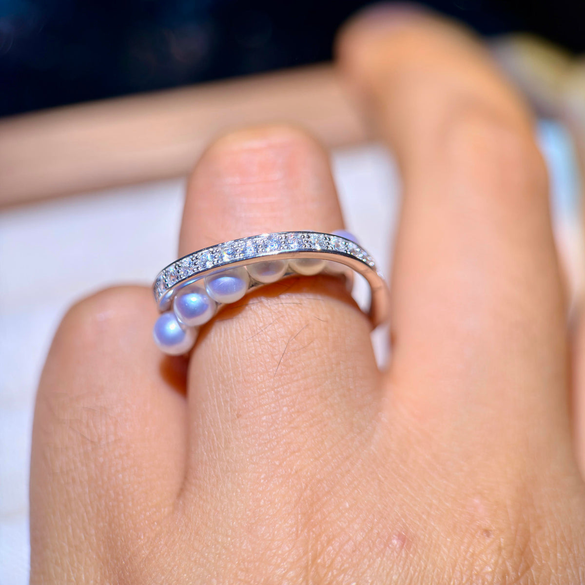 Celestial statement ring featuring multiple luminous white pearls.