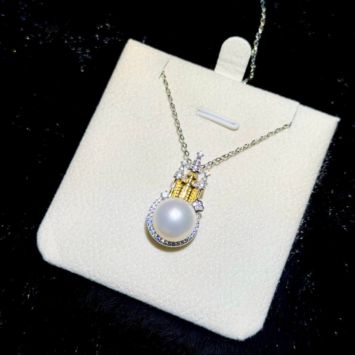 Princess-inspired sterling silver necklace with sparkling castle details and white pearl.