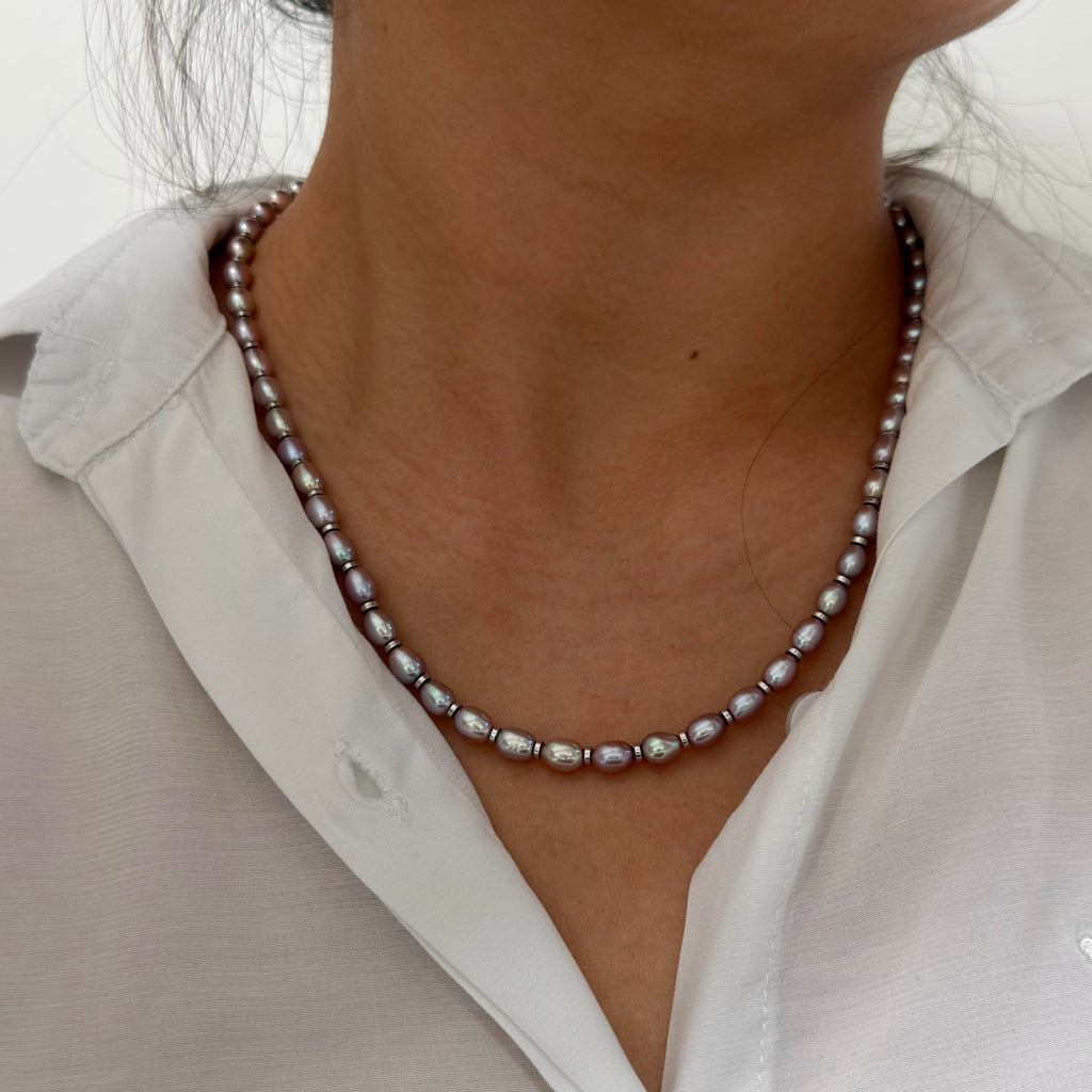 Model wearing the iridescent purple freshwater pearl necklace.