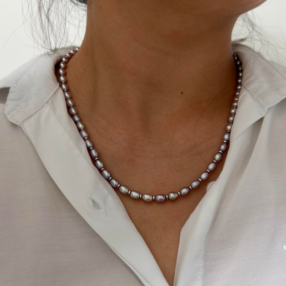 Model wearing the iridescent purple freshwater pearl necklace.