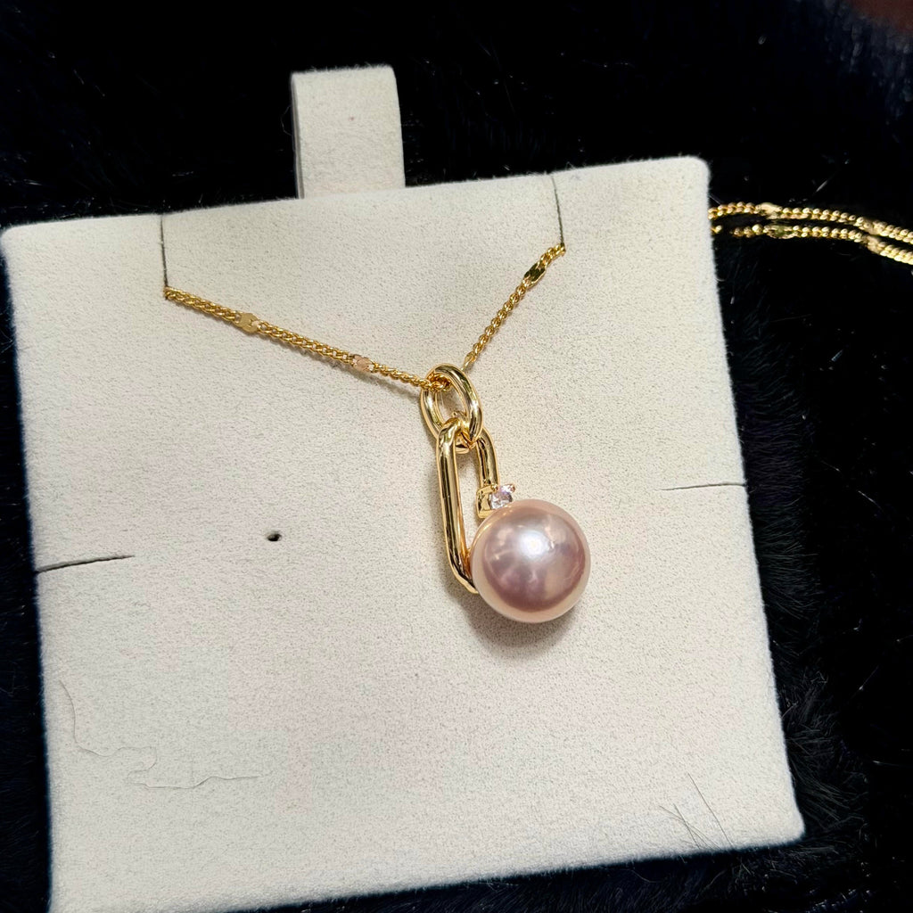 Gold-plated pearl pendant with a small sparkling zirconia accent.