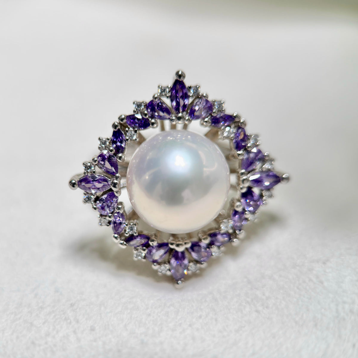 11.4 mm white freshwater pearl ring with purple zirconia floral halo.