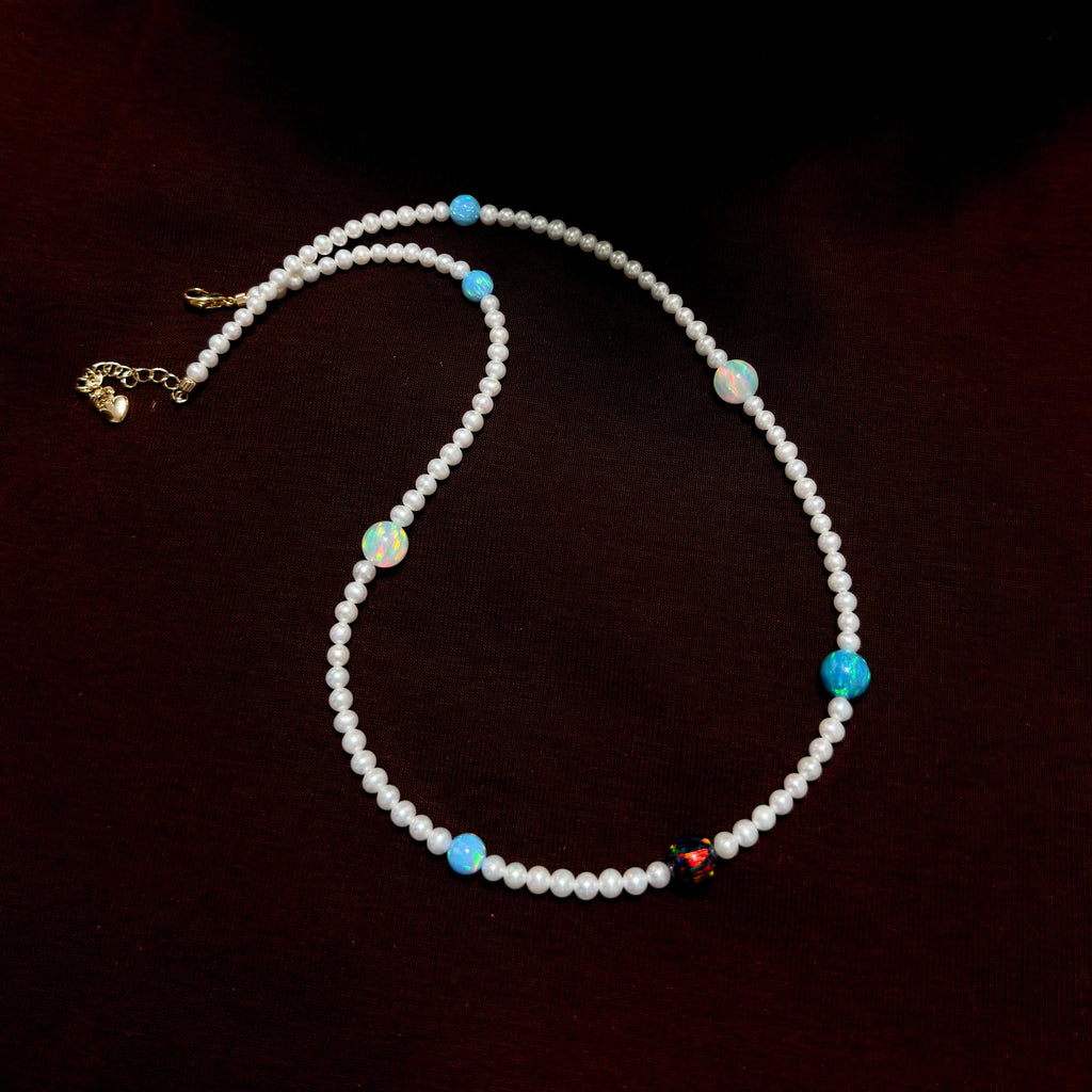 Celestial-inspired necklace with white freshwater pearls and mixed colourful opals.
