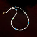 Celestial-inspired necklace with white freshwater pearls and mixed colourful opals.
