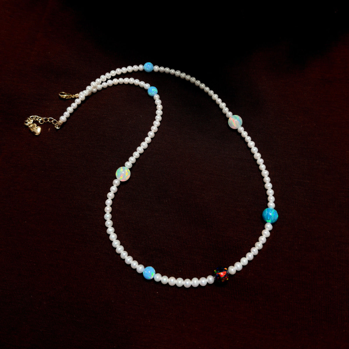 Celestial-inspired necklace with white freshwater pearls and mixed colourful opals.
