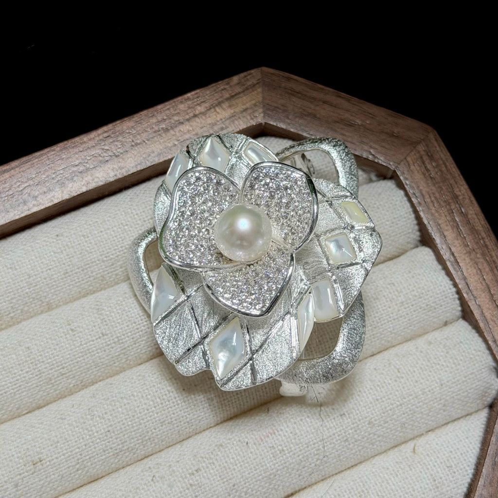 Luminous white freshwater pearl brooch with sculptural floral detailing