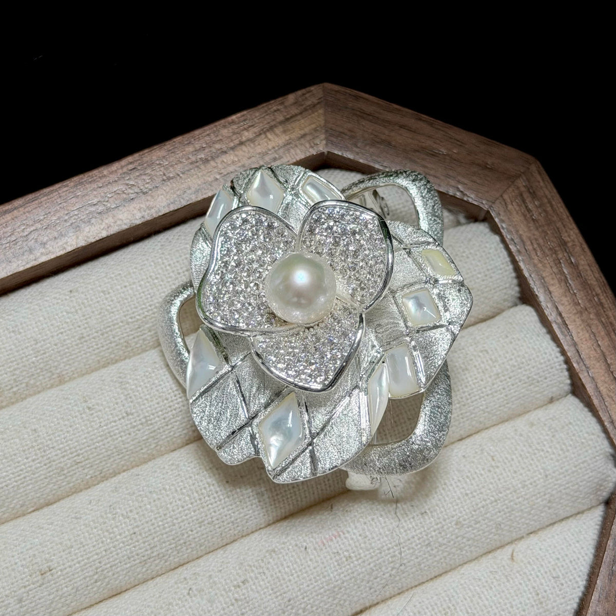 Luminous white freshwater pearl brooch with sculptural floral detailing