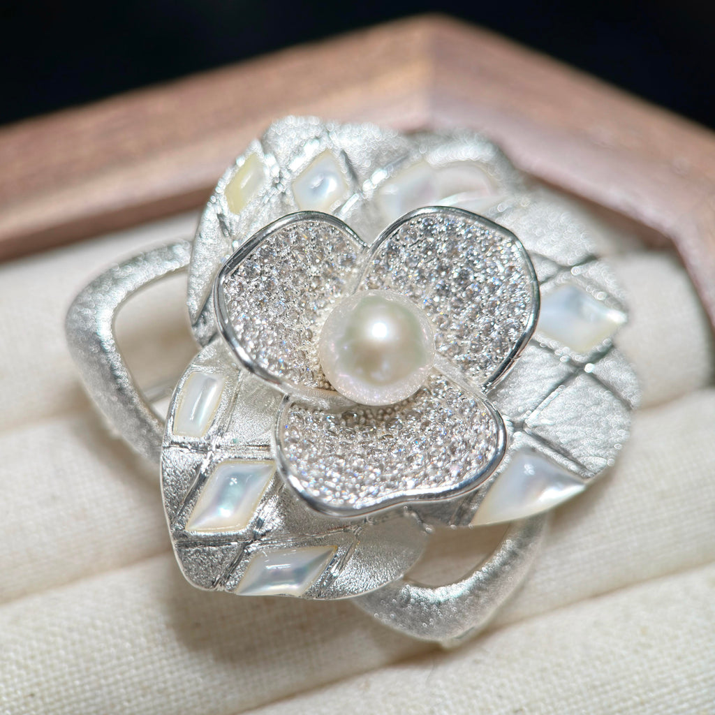 9 mm cool white freshwater pearl camellia brooch with an elegant floral design.

