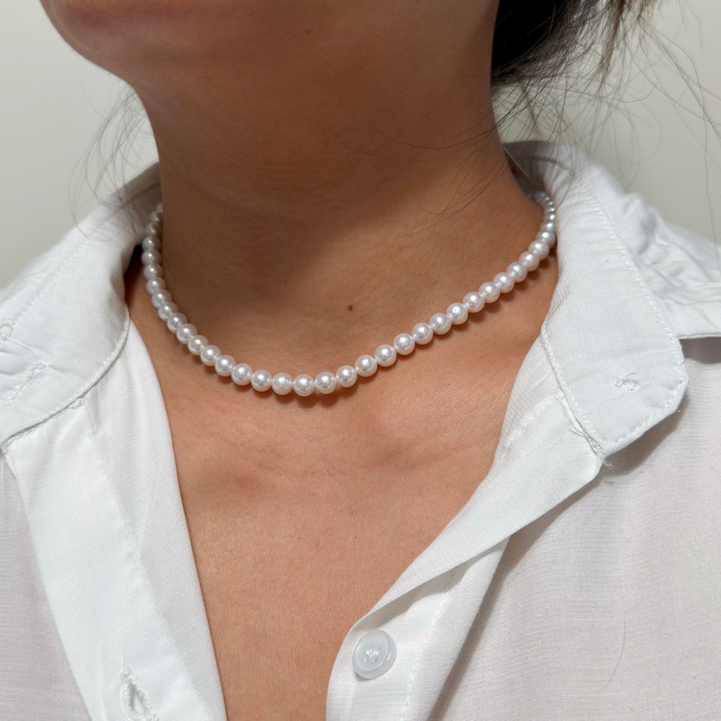 Close-up of 6–7 mm cool white with blue-silver iridescence freshwater pearl necklace, 41 cm long.