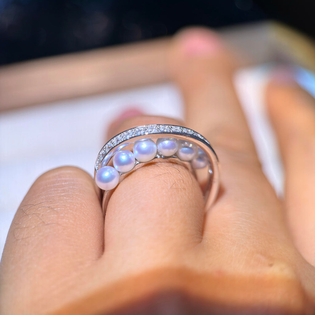 Modern silver ring with a row of bright freshwater pearls.