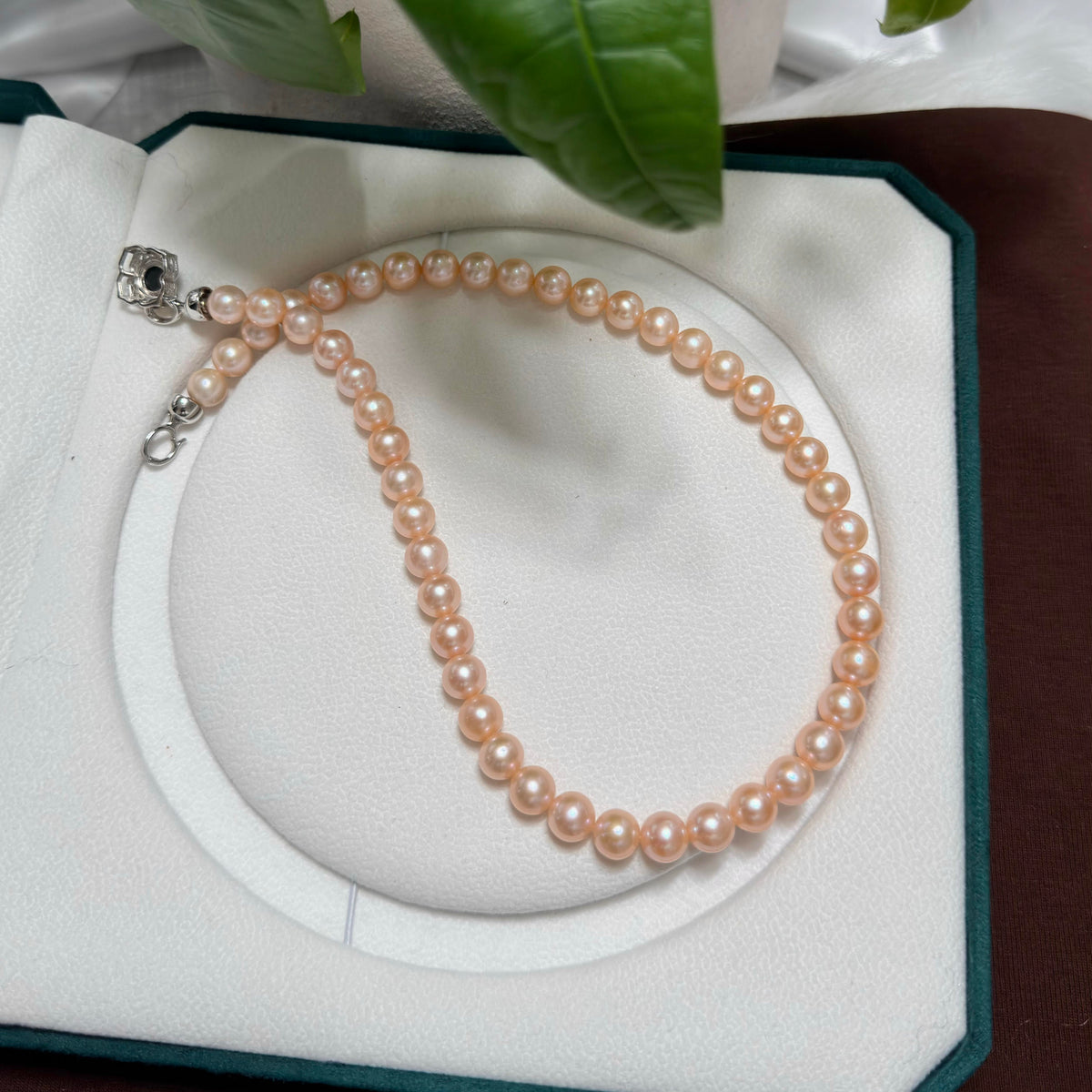 Classic single-strand necklace made with light-orange freshwater pearls.
