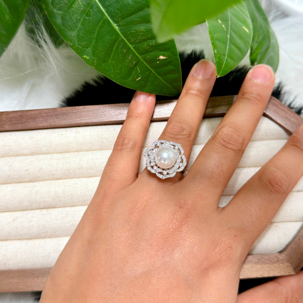 White freshwater pearl camellia ring with delicate soft pink iridescent halo.