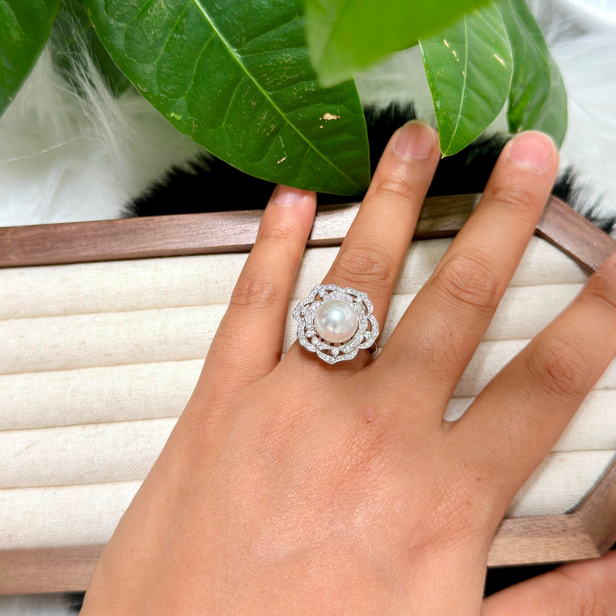 White freshwater pearl camellia ring with delicate soft pink iridescent halo.