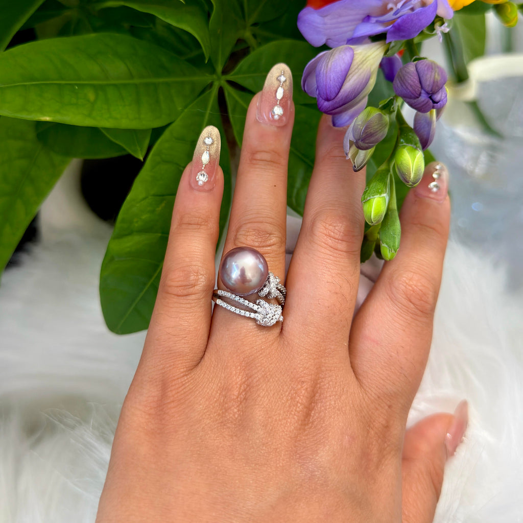 Statement purple pearl ring with an adjustable sterling silver band on hand.