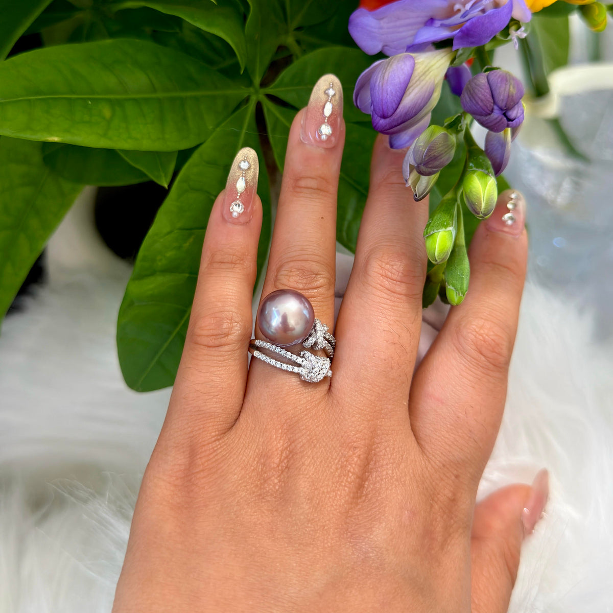 Statement purple pearl ring with an adjustable sterling silver band on hand.