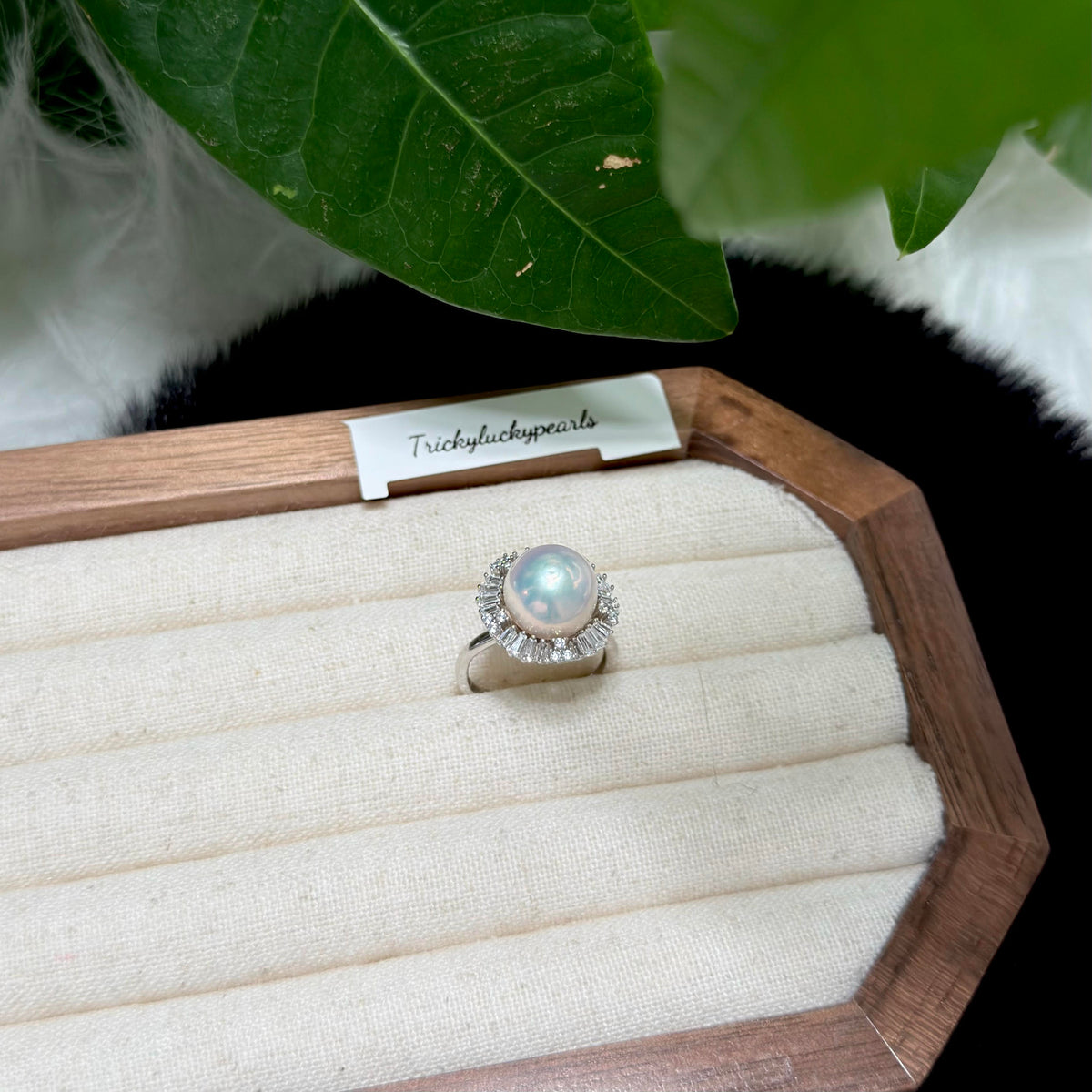 Sparkling zirconia halo surrounding a luminous white pearl.