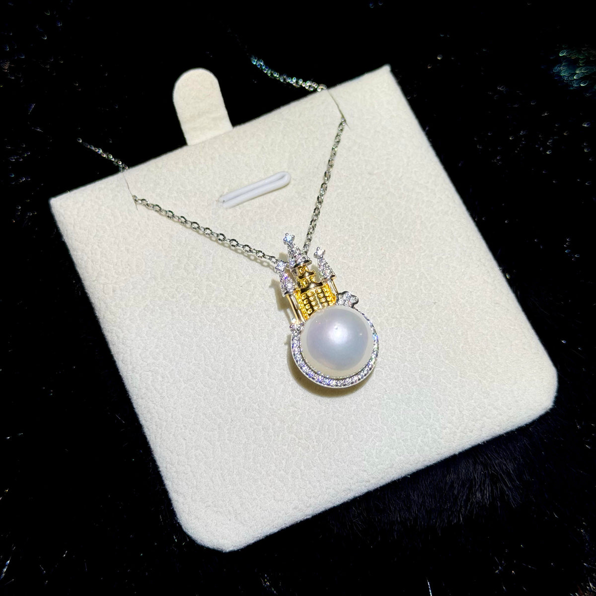 Two-tone silver and gold castle pendant with a luminous freshwater pearl.